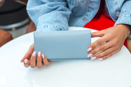 A purse on a white table in the hands