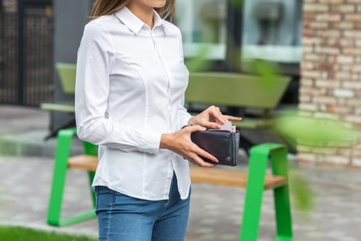 Girl in white holds an open wallet