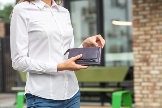 Girl in white holds an open wallet