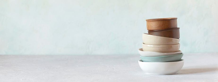 stack of different ceramic bowls, side view, banner, copy space, rustic style