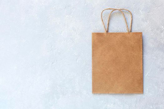 craft paper bag on the grey concrete background, top view, copyspace, zero waste concept,