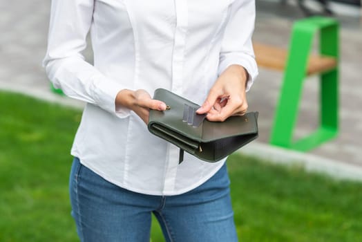 Girl in white holds an open wallet