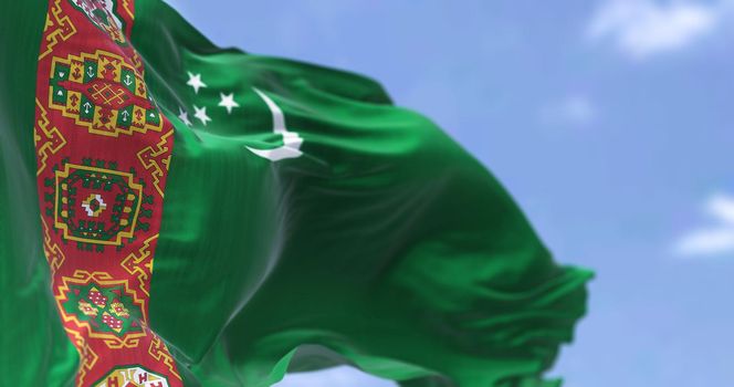 Detail of the national flag of Turkmenistan waving in the wind on a clear day. Turkmenistan is a landlocked country in Central Asia. Selective focus.