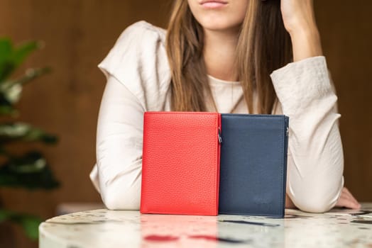 Two wallets on table, red and blue