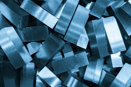 pile of rectangular steel workpieces after surface grinding, full-frame closeup background