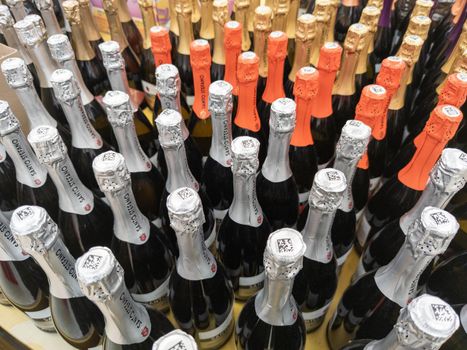 many bottles of champagne in a grocery store closeup with selective focus and wide angle in Tula, Russia - March 3, 2022