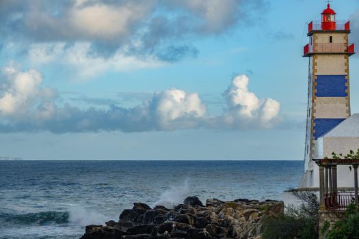 Rear view of lighthouse and ocean at dusk