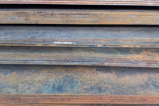 stack of mild steel sheets, full-frame close-up view with selective focus, industrial material background
