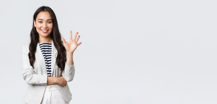 Business, finance and employment, female successful entrepreneurs concept. Successful female businesswoman, asian real estate broker pointing finger, showing number five and smiling.