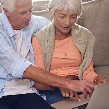Shot of a senior couple using a laptop at home.