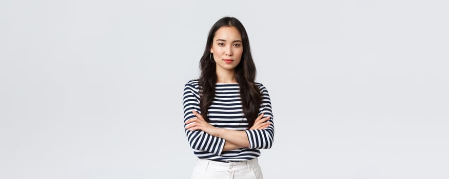 Lifestyle, people emotions and casual concept. Confident nice smiling asian woman cross arms chest confident, ready to help, listening to coworkers, taking part conversation.