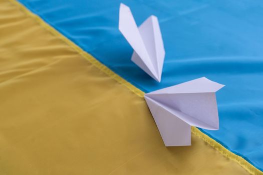 Save Ukraine. Two paper airplanes with the flag of Ukraine, help and charity. Art collage