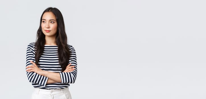 Lifestyle, people emotions and casual concept. Confident nice smiling asian woman cross arms chest confident, ready to help, listening to coworkers, taking part conversation.