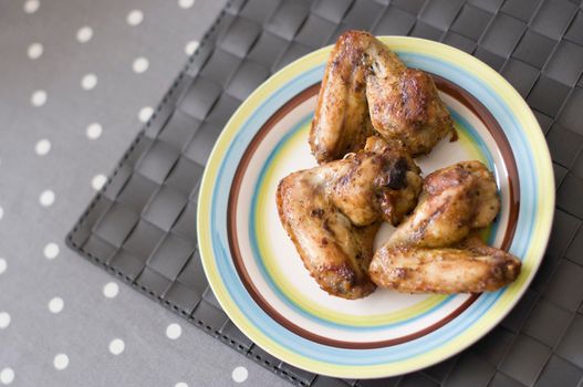 grilled chicken wings close up on the plate on the table, Meat food concept. High quality photo