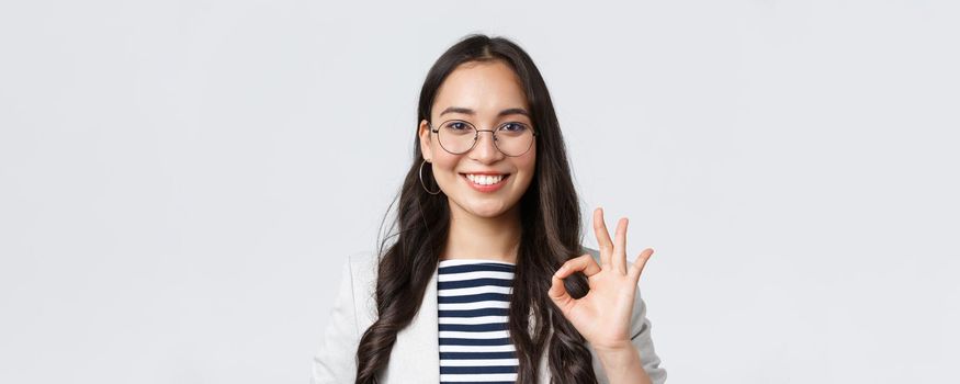 Business, finance and employment, female successful entrepreneurs concept. Close-up of professional real estate broker guarantee quality of her service, showing okay sign and smiling confident.