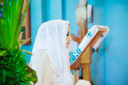 rear view of bride waiting in a crowded church