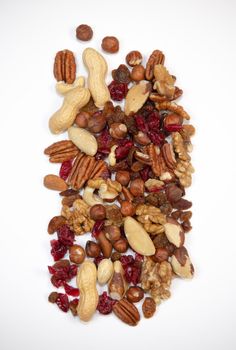 Mixed nuts and dried fruits in wooden bowl on white background, copy space, Healthy snack, mix of organic nuts and dry fruits