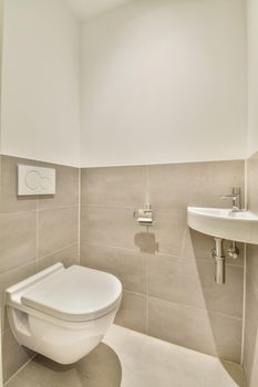 The interior of a bathroom in a modern house with a toilet and a sink