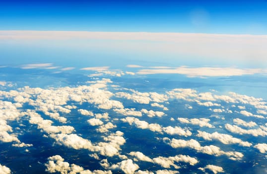 Fluffy white clouds and blue sky seen from airplane. flight cloud sky