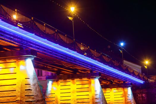 bridge night city reflected in water with lights and reflections. Uzghorod Uzhhorod