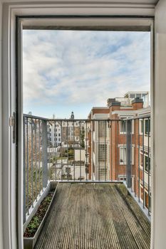 Access to a small balcony with a view of the city landscape from a modern house