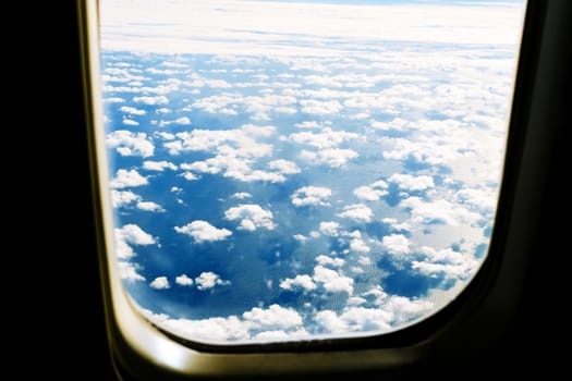 Fluffy white clouds and blue sky seen from airplane. flight cloud sky