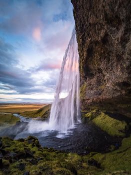 Seljalandsfoss waterfall at dawn, vertical composition, Iceland