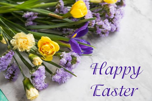 Easter greeting with a bouquet of daffodils and a text Happy Easter