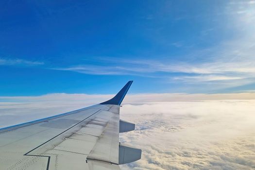 Beautiful view from the window of a flying plane against the background of clouds