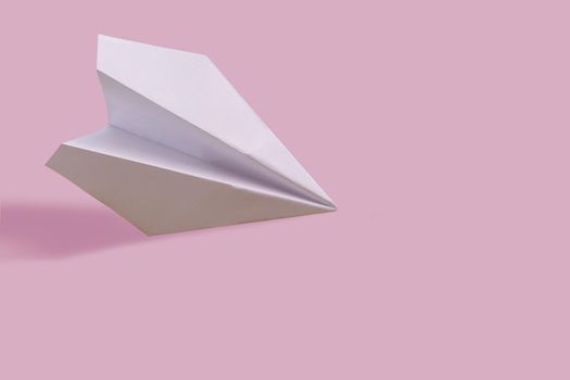 White paper plane on color background, travel and holiday concept