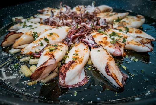 Cooked squid paella closeup view