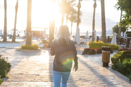 Woman in summer on hotel grounds. Summer evenings in tourist hotels concept.