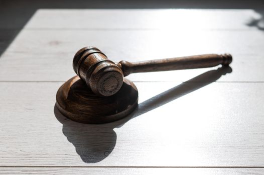 Wooden judicial gavel on a wooden laminate