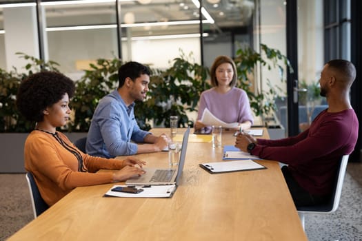 Diverse group of business people working in creative office. group of people in a meeting discussing work. business people and work colleagues at a busy creative office.