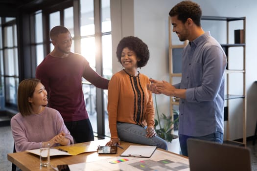 Diverse group of business people working in creative office. group of people in a meeting discussing work. business people and work colleagues at a busy creative office.