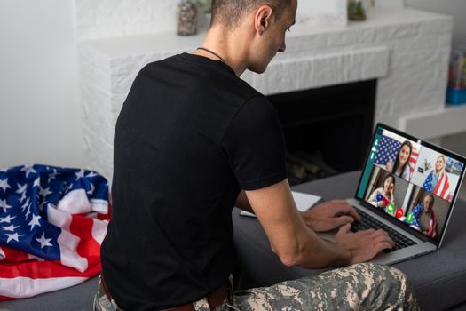 American caucasian soldier in USA military uniform in front of the computer