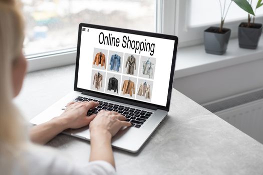 Online Shopping Website on Laptop. Easy E-commerce Website Shop by Smartphone, iPhone, iPad and Laptop. Close up Hands Using Smartphone Shopping Cart read Online Article, Blog. Digital Payment gateway.