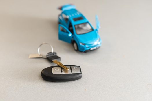 Toy car and keys isolated on white background.