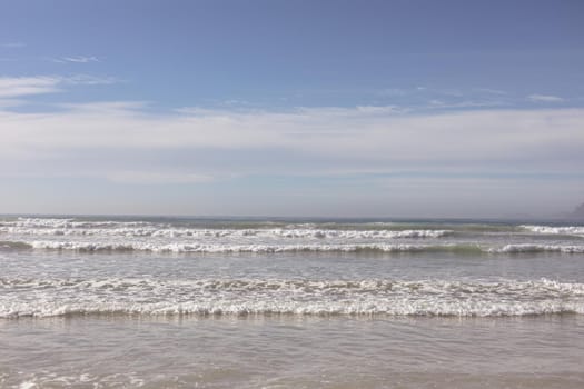 View of beautiful waves of the sea and the beach against blue sky. family travel vacation leisure concept