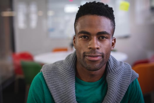 Portrait of happy african american businessman sitting at the office room smiling. independent creative design business.