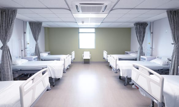 General view of an empty hospital room with two rows of beds. medicine, health and healthcare services.