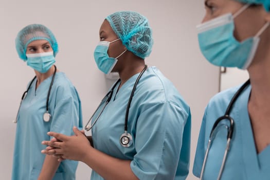 Portrait of diverse group of male and female doctors standing in operating theatre. medicine, health and healthcare services.