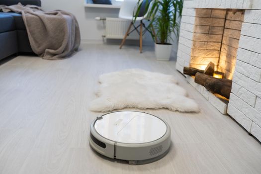 robotic vacuum cleaner on laminate wood floor smart cleaning technology.