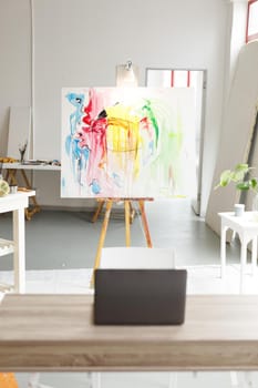 Modern abstract oil painting on canvas sitting on easel in artists studio. creation and inspiration at an artists painting studio.