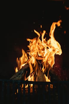 Flames in the hearth of an open fireplace, warming a family home. domestic lifestyle and traditional home comforts.