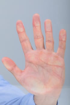 Close up of caucasian businessman touching virtual interface, isolated on grey background. business technology, communication and growth concept.