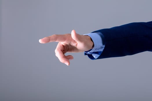 Midsection of caucasian businessman touching virtual interface, isolated on grey background. business technology, communication and growth concept.