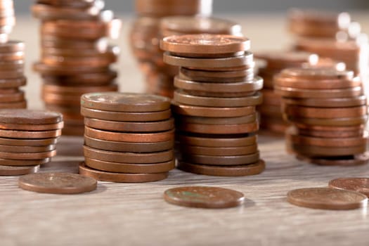 Close up of piles of coins on table, isolated on grey background. business technology, communication and growth concept.