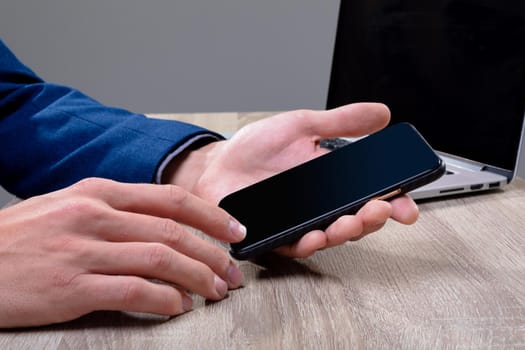 Midsection of caucasian businessman using smartphone and laptop, isolated on grey background. business technology, communication and growth concept digitally generated composite image.