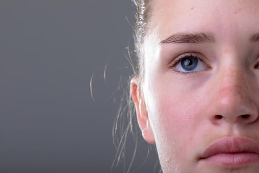 Close up of face of caucasian businesswoman, isolated on grey background. business technology, communication and growth concept digitally generated composite image.